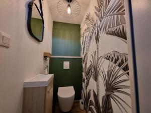 a bathroom with a toilet and a sink and a mirror at La Tanière de la baie - Maison 6-8 pers in Le Val-Saint-Père +32 photos