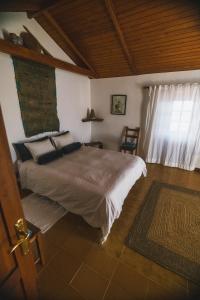a bedroom with a large bed and a window at Casa Muna in El Cercado
