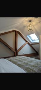 a bedroom with a roof with a window and a bed at Rokeby cottage in Drogheda