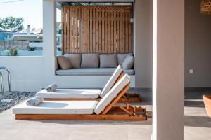 a living room with two lounge chairs and a couch at Acacia - Explore your senses in Preveza