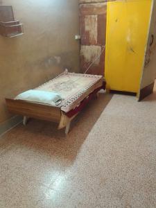 a bed in a room with a yellow door at lotus Abode in Salem