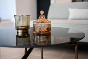 a bird cage sitting on a glass table at Acacia - Explore your senses in Preveza
