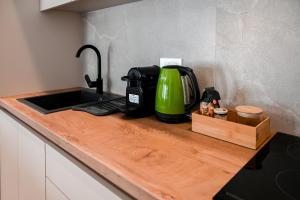 a kitchen counter with a green appliance on it at Acacia - Explore your senses in Preveza