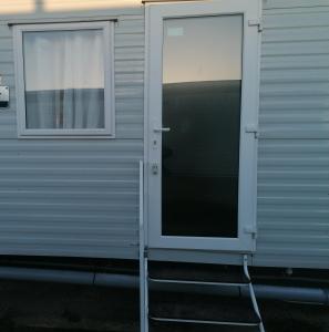 two windows on the side of a trailer at 4-Bedroom Caravan static home in Clacton-on-Sea in Clacton-on-Sea