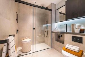 a bathroom with a shower and a toilet and a sink at Executive Luxury apartment in Vauxhall with balcony in London