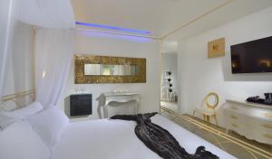 a bedroom with a white bed and a fireplace at Hotel Metropolitan in Bologna