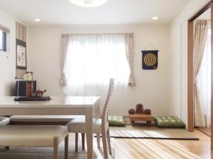 a dining room with a table and chairs and a window at Tokyo Center Ikebukuro Family villa quiet 4BR group stay & parking near JR in Tokyo