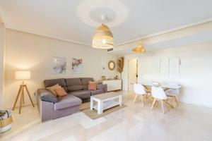 a living room with a couch and a table at VB Amapolas 2BDR Sea views & relax in Benalmádena