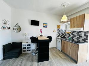 a kitchen with a table and a counter in a room at Giovanni Apartments Kos Studio 20 in Kos