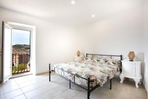 a bedroom with a bed and a large window at Tourist Apartment anna in Bracciano