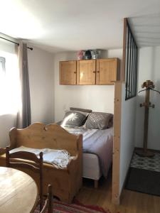 a bedroom with a bed and a loft bed at location studio de 2 - 4 personnes in Hautecour