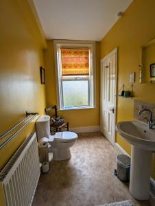 a bathroom with a toilet and a sink at Number 18 in Whitby