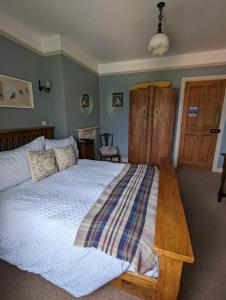 a bedroom with a large bed and a wooden table at Number 18 in Whitby