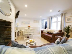 a living room with a couch and a table at Bosuns Locker in Port Isaac