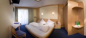 A bed or beds in a room at Hotel Vomperhof