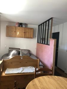 a small room with a bed and a table at location studio de 2 - 4 personnes in Hautecour