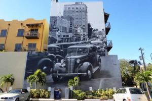 a large painting of cars parked in a parking lot at Burns Square Hotel in Sarasota