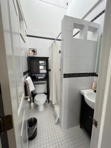 a bathroom with a toilet and a sink at Burns Square Hotel in Sarasota