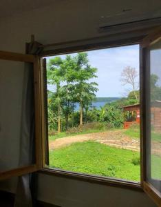 a window with a view of a field of grass at Kingfisher- Principe in Santo António