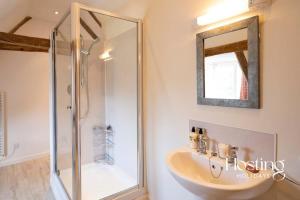 a bathroom with a shower and a sink at Bullocks Farm House - 6 Exceptional Bedrooms in High Wycombe