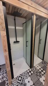 a room with glass doors and a checkered floor at SURF HOSTEL BIARRITZ in Biarritz