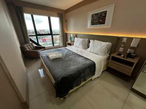 a hotel room with a bed and a window at Alugueasy - Hotel Cullinan in Brasilia