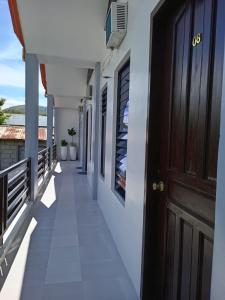 a corridor on the balcony of a house at Leo Green Apartelle in Jagna