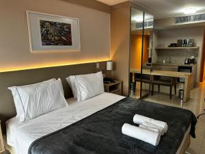 a bedroom with a bed with two towels on it at Alugueasy - Hotel Cullinan in Brasilia