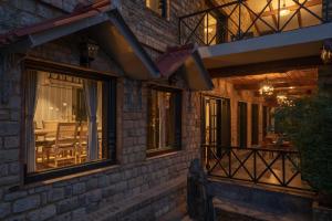 a brick house with windows and a dining area at Buransh Terraces Luxury 3&4BHK Villas with Mountain View & Caretaker & Kitchen & Complementary Breakfast in Bhowāli