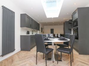a kitchen and dining room with a table and chairs at Park View in Llandudno