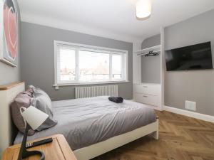 a bedroom with a bed and a large window at Park View Upper in Llandudno