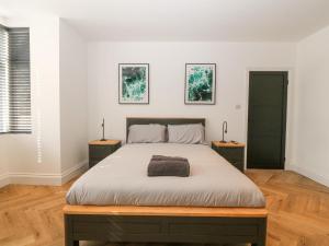 a bedroom with a large bed with two night stands at Park View in Llandudno