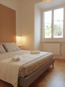 a bedroom with a bed with two towels on it at Flaminia71 in Rome