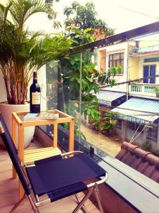 een fles wijn op een tafel op een balkon bij Adora for Expat in Can Tho