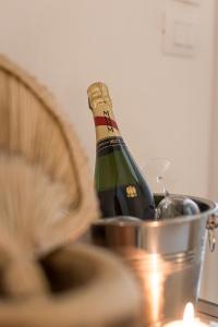eine Flasche Champagner in einem Eimer auf einem Tisch in der Unterkunft Guerrieri Suites & Spa in Campi Salentina