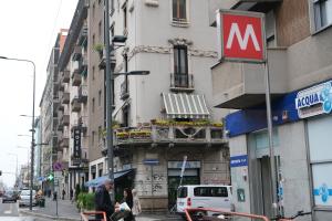 a group of people walking down a street in front of a building at Hotel Nuovo Metrò in Milan