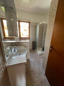 a bathroom with a sink and a shower at La Casa Sul Lago - SlowLife in Passignano sul Trasimeno +54 photos