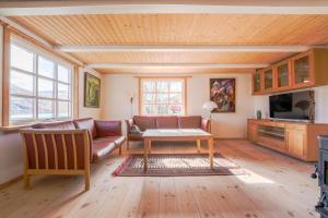 a living room with a couch and a table at Lovely 4 Bedroom House in Vestmanna in Vestmanna