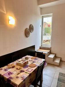 a dining room with a table and a window at San Lollo Room in Rome