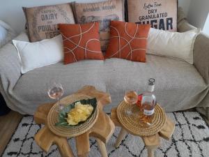 a living room with two tables with wine glasses and a couch at Marina Bella in Cogolin +48 photos