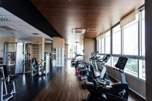 a gym with a row of treadmills and cardio machines at ADD Berrini in Sao Paulo