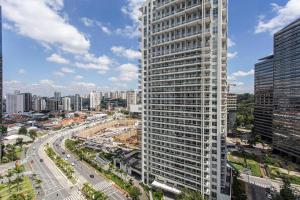 a tall white building in a city with a street at ADD Berrini in Sao Paulo