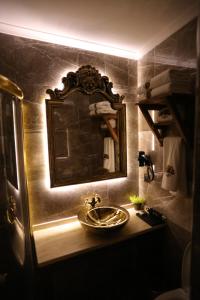 a bathroom with a sink and a mirror at La Perla Boutique Hotel in İskenderun