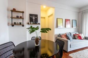 a living room with a table and a couch at ADD Berrini in Sao Paulo