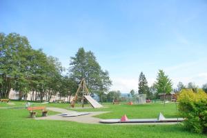 a park with a playground with a slide and benches at RELAX - GREEN mit Pool und Sauna in Scheidegg