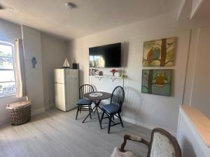 a kitchen with a table and chairs and a refrigerator at Dream Studio on the Beach in Miami Beach
