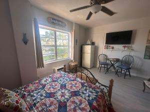 a bedroom with a bed with a quilt on it at Dream Studio on the Beach in Miami Beach