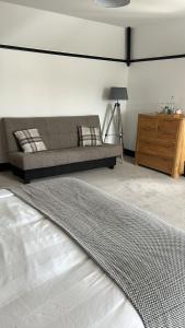 a living room with a bed and a couch at The Fishmongers Tavern in Sheringham