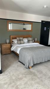 a bedroom with a large bed and a window at The Fishmongers Tavern in Sheringham