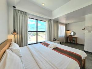 Ένα ή περισσότερα κρεβάτια σε δωμάτιο στο 39 Living Pattaya